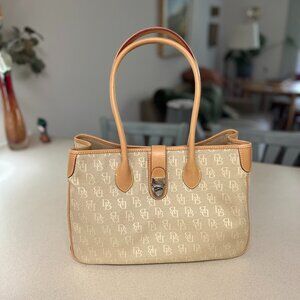 Dooney & Bourke canvas satchel, cream color with tan leather trim and handles.